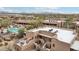 Breathtaking aerial view of the community showcasing pools, desert landscaping, and property layout at 36601 N Mule Train Rd # C38, Carefree, AZ 85377