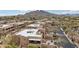 Aerial of clustered tan condos with rooftop decks in a desert landscape at 36601 N Mule Train Rd # C38, Carefree, AZ 85377