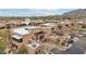 Aerial view of the properties showcasing its patios, desert landscaping, and mountain views at 36601 N Mule Train Rd # C38, Carefree, AZ 85377