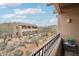 Picturesque balcony view of desert landscaping, buildings, and distant mountains against a beautiful blue sky at 36601 N Mule Train Rd # C38, Carefree, AZ 85377