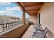 Relaxing balcony with wrought iron seating, overlooks well-maintained outdoor space and nearby building at 36601 N Mule Train Rd # C38, Carefree, AZ 85377