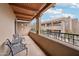 Inviting balcony with wooden ceiling, iron railings, and comfortable seating showcasing the building's architectural design at 36601 N Mule Train Rd # C38, Carefree, AZ 85377