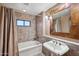 Updated bathroom featuring a bathtub, shower, and tiled walls at 36601 N Mule Train Rd # C38, Carefree, AZ 85377