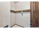 A view of the empty walk in closet with a wooden hanging rod at 36601 N Mule Train Rd # C38, Carefree, AZ 85377