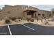 Desert landscaping surrounds clubhouse exterior with marked parking spots at 36601 N Mule Train Rd # C38, Carefree, AZ 85377