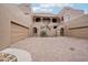 Charming home featuring a courtyard with dual garage doors and gated entrances at 36601 N Mule Train Rd # C38, Carefree, AZ 85377