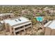 Tan condos surrounding a vibrant blue pool with lounge chairs under red umbrellas at 36601 N Mule Train Rd # C38, Carefree, AZ 85377