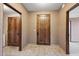 Hallway featuring tiled floors, wood doors and neutral walls that create a warm and inviting transition space at 36601 N Mule Train Rd # C38, Carefree, AZ 85377