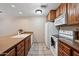 Well-lit kitchen featuring tile floors, wood cabinets, white appliances, and durable countertops at 36601 N Mule Train Rd # C38, Carefree, AZ 85377