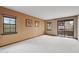 Bright living room with a sliding glass door to balcony, filled with natural light and neutral carpeting at 36601 N Mule Train Rd # C38, Carefree, AZ 85377