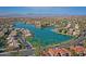 A scenic aerial view of a lakeside community with palm trees lining the shore under a blue sky at 3830 E Lakewood E Pkwy # 2009, Phoenix, AZ 85048