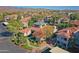 Aerial view of condo community featuring lush trees and landscaping, with the leasing office visible at 3830 E Lakewood E Pkwy # 2009, Phoenix, AZ 85048