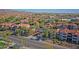 Community aerial view showcasing condominiums, tree-lined streets, lush greenery, and mature palm trees at 3830 E Lakewood E Pkwy # 2009, Phoenix, AZ 85048