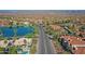 Expansive aerial shot showcasing the community with tiled roofed homes, a serene lake, and scenic mountain views at 3830 E Lakewood E Pkwy # 2009, Phoenix, AZ 85048