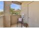 This balcony features textured columns and a view of the surrounding vegetation at 3830 E Lakewood E Pkwy # 2009, Phoenix, AZ 85048