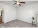 This bedroom features neutral carpet, white walls, and a ceiling fan with a light fixture at 3830 E Lakewood E Pkwy # 2009, Phoenix, AZ 85048