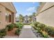 Entrance to a well-manicured community lined with flowers, greenery, palm trees, and beautiful buildings at 3830 E Lakewood E Pkwy # 2009, Phoenix, AZ 85048