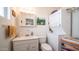 White bathroom featuring sink, toilet, medicine cabinet, and washer/dryer at 384 Gypsum Dr, Apache Junction, AZ 85119