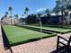 View of bocce ball court surrounded by desert landscaping, palm trees and modular homes at 384 Gypsum Dr, Apache Junction, AZ 85119