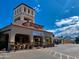 Golden Vista Resort clubhouse showcases a charming facade with a tower, inviting entrance, and ample parking at 384 Gypsum Dr, Apache Junction, AZ 85119