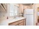 Kitchen featuring white countertops, cabinets, a stainless steel sink, and a refrigerator at 384 Gypsum Dr, Apache Junction, AZ 85119