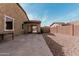 A large, open backyard with stone and a covered extension providing ample space for outdoor entertaining and relaxation at 4187 N 183Rd Dr, Goodyear, AZ 85395