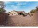 Large gravel backyard with a pool, covered patio, and mature landscaping at 4187 N 183Rd Dr, Goodyear, AZ 85395