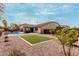 Expansive backyard featuring a sparkling pool, covered patio, and low-maintenance landscaping at 4187 N 183Rd Dr, Goodyear, AZ 85395