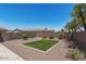 The backyard features an open space with a patch of artificial grass, perfect for outdoor activities at 4187 N 183Rd Dr, Goodyear, AZ 85395