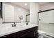 Modern bathroom features double sinks with framed mirror and glass enclosed shower for a spa-like experience at 4187 N 183Rd Dr, Goodyear, AZ 85395