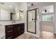 Bathroom featuring a glass shower, vanity with storage, and neutral color palette at 4187 N 183Rd Dr, Goodyear, AZ 85395