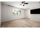 Bright bedroom with large window, ceiling fan, and neutral tones for a calming atmosphere at 4187 N 183Rd Dr, Goodyear, AZ 85395