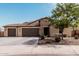 Charming single-story home with stone accents, a three-car garage, and a beautifully landscaped front yard at 4187 N 183Rd Dr, Goodyear, AZ 85395