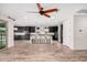 Spacious kitchen featuring dark cabinetry, a large island, stainless steel appliances, and wood-look floors at 4187 N 183Rd Dr, Goodyear, AZ 85395