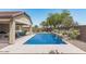 Stunning pool area with stone accents and lush landscaping for a serene backyard oasis at 4187 N 183Rd Dr, Goodyear, AZ 85395