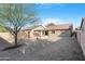 Well maintained backyard with gravel landscaping, covered patio, and healthy trees, perfect for relaxing and enjoying nature at 44321 Cypress Ln, Maricopa, AZ 85138