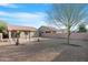 The backyard features low maintenance gravel and a covered patio, perfect for outdoor entertaining and enjoying the weather at 44321 Cypress Ln, Maricopa, AZ 85138