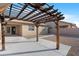 The spacious backyard patio offers a concrete foundation and beautiful pergola, ideal for outdoor gatherings and relaxation at 44321 Cypress Ln, Maricopa, AZ 85138