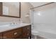 Bathroom with dark wood vanity with a sink and a framed mirror above the sink at 44321 Cypress Ln, Maricopa, AZ 85138