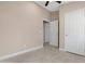 Empty bedroom with a view into another room, a ceiling fan, and tile flooring at 44321 Cypress Ln, Maricopa, AZ 85138