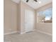 Neutral bedroom featuring a ceiling fan, window with blinds, and tile flooring at 44321 Cypress Ln, Maricopa, AZ 85138