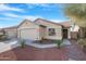 Inviting home exterior with desert landscaping, rock mulch, and a paved walkway leading to the front door at 44321 Cypress Ln, Maricopa, AZ 85138