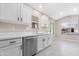 Bright kitchen features white cabinetry, stainless steel appliances, quartz countertops, and updated fixtures at 44321 Cypress Ln, Maricopa, AZ 85138