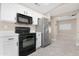 Modern kitchen featuring sleek appliances, ample cabinet space, and a seamless transition to adjacent living areas at 44321 Cypress Ln, Maricopa, AZ 85138