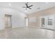 Spacious living room with high ceilings, tile floors, and access to the backyard at 44321 Cypress Ln, Maricopa, AZ 85138