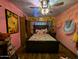 Bedroom with pastel-colored walls, wood laminate flooring, and crystal chandelier at 45020 N 18Th St, New River, AZ 85087