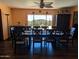 Traditional dining room with dark wood floors, a large table, and scenic views from a window at 45020 N 18Th St, New River, AZ 85087