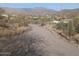 Long gravel driveway leading up to a desert home with mountain views in the background at 45020 N 18Th St, New River, AZ 85087