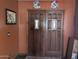 Warm interior view of a double front door with decorative accents and orange walls at 45020 N 18Th St, New River, AZ 85087