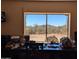 The window in this office provides a view of desert hills and cacti under a clear blue sky at 45020 N 18Th St, New River, AZ 85087